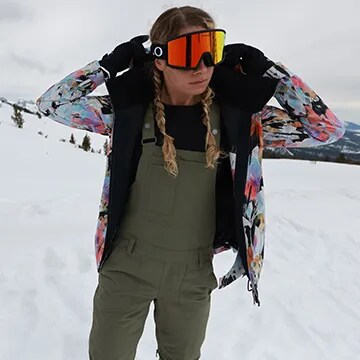Woman outside in ski goggles.
