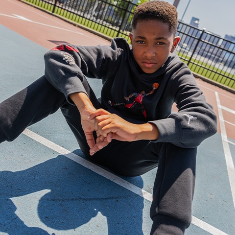 Boy on a basketball court wearing Nike.