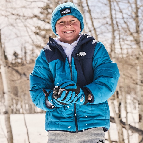 Boy making a snowball.