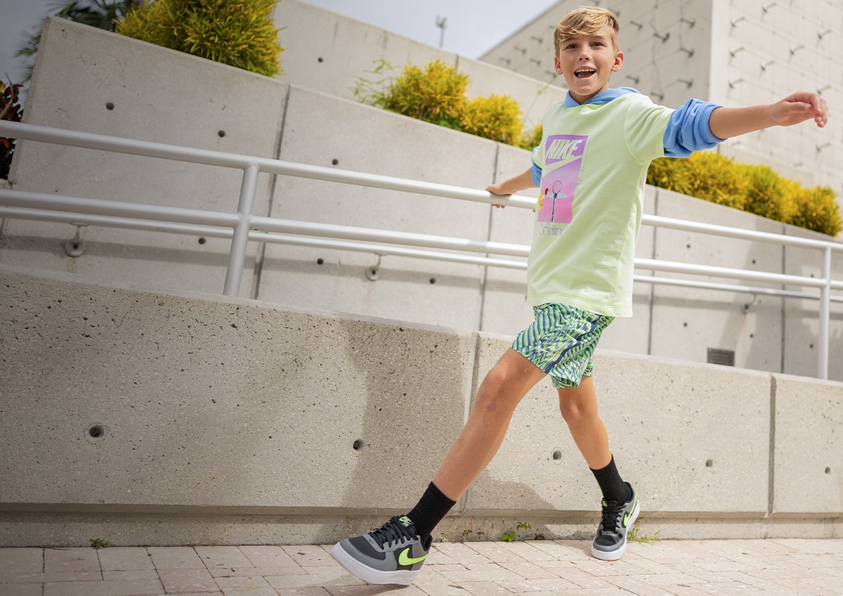 A boy walking down a street.