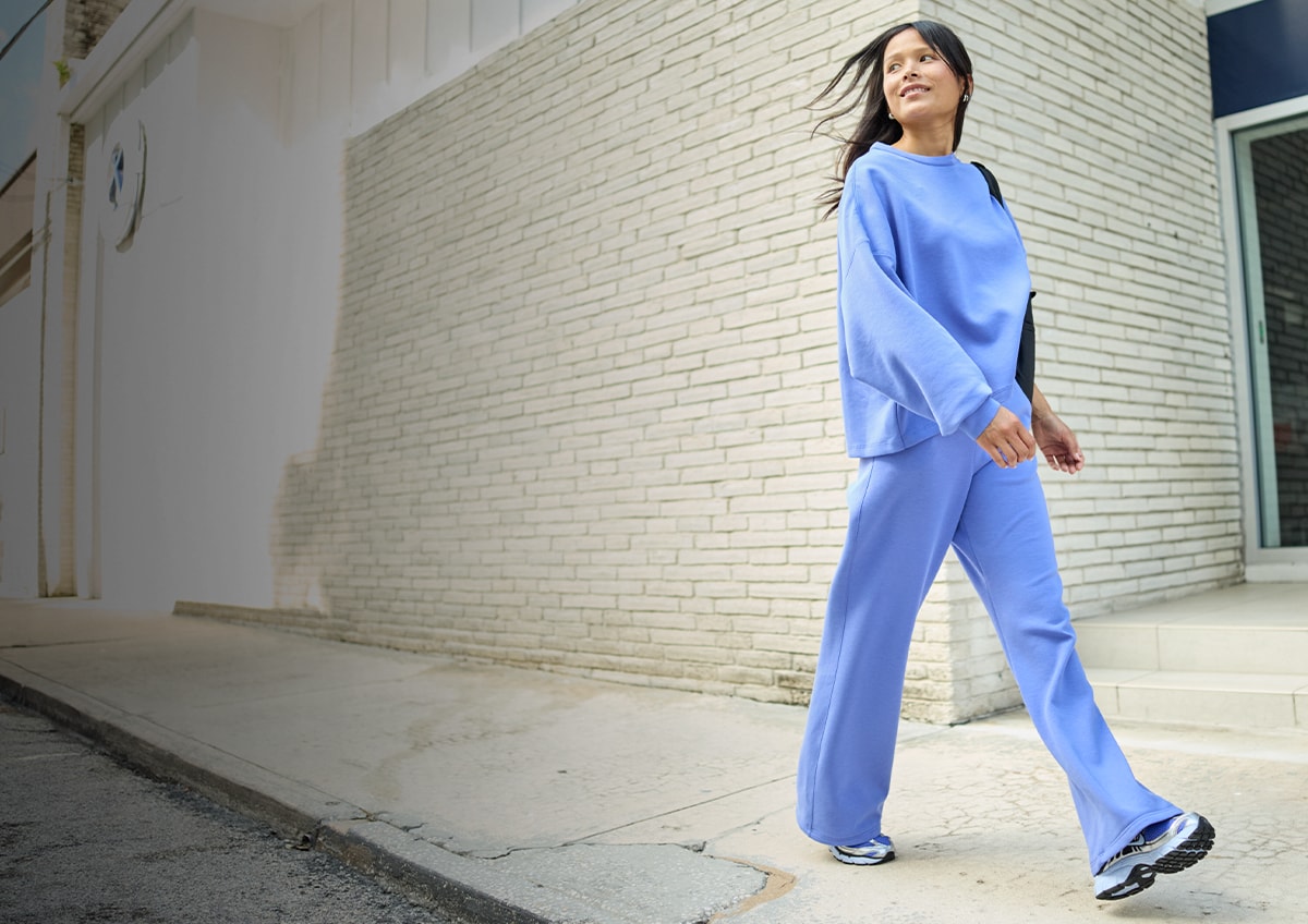 A woman walking down a street.