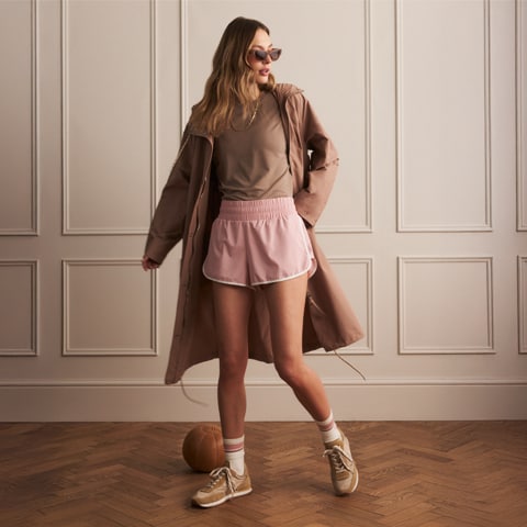 A woman standing in a hallway.