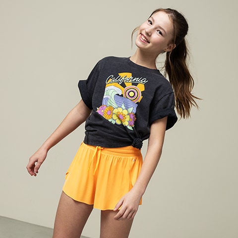 A girl in a tee and shorts.