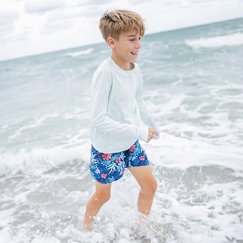 Boy swimming on the beach.