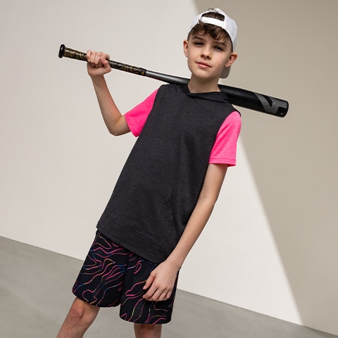 Boy standing with a baseball bat.