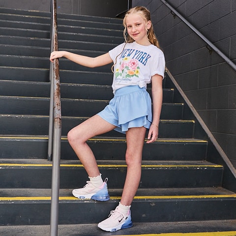 A girl standing on steps.