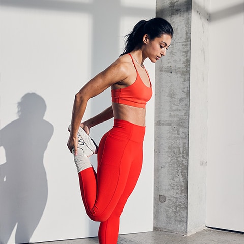 A woman stretching in a studio.