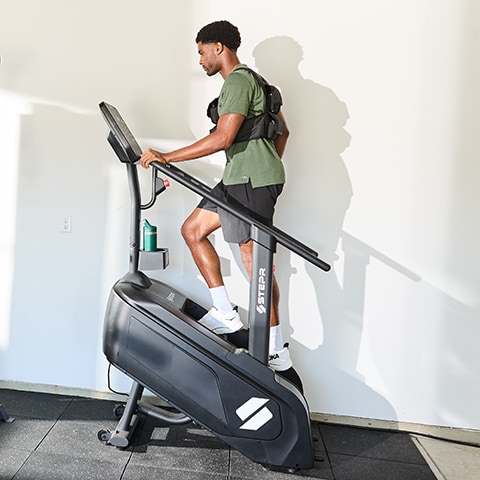 A man exercising on a stair climber