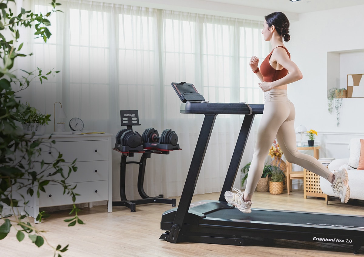 A woman using a SOLE brand treadmill