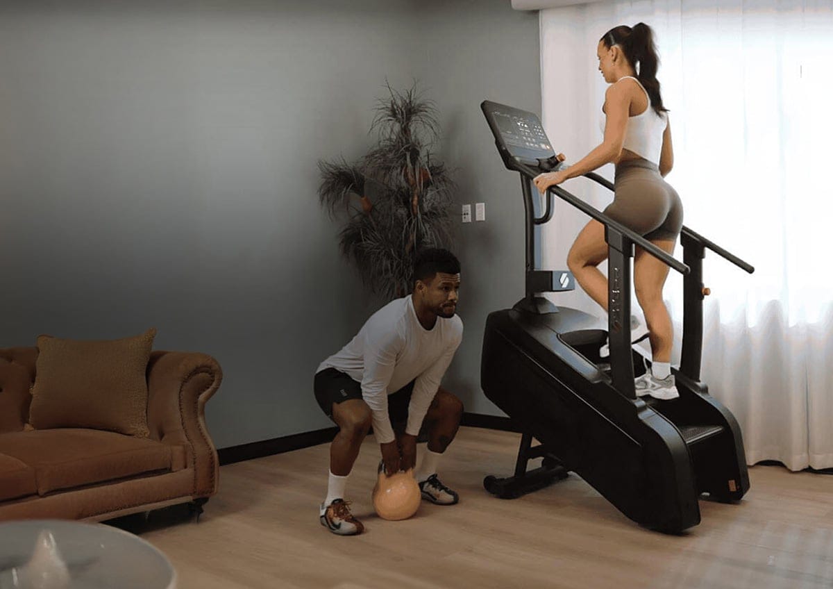 A woman working out on a Stepr brand stain machine