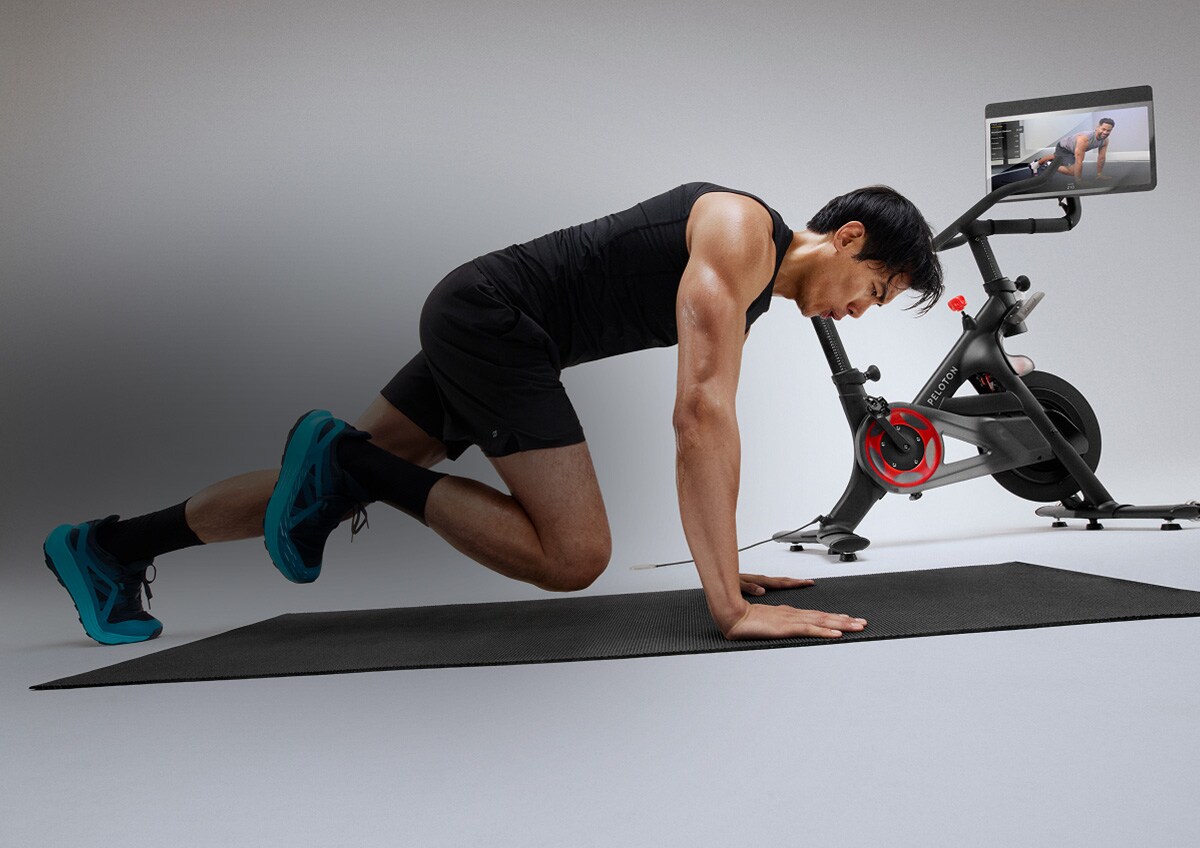 A man working out with a Peloton Bike