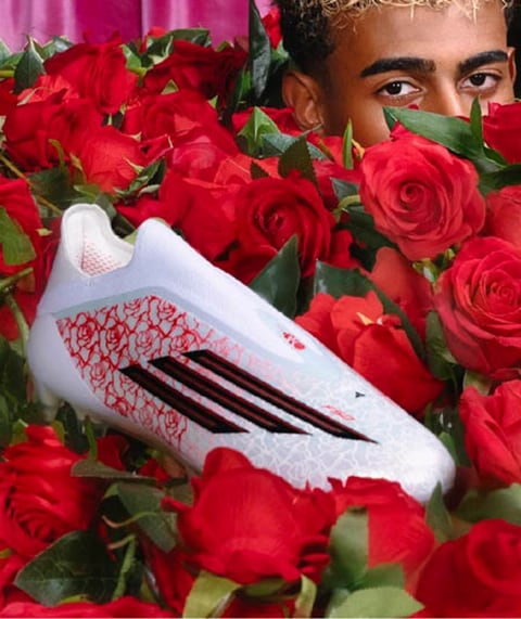 F50 Soccer Cleat in bed of flowers.