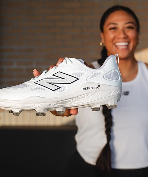 Megan Faraimo holding a softball cleat.