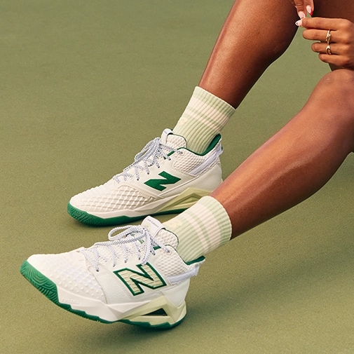 Close up of tennis player's New Balance shoes.
