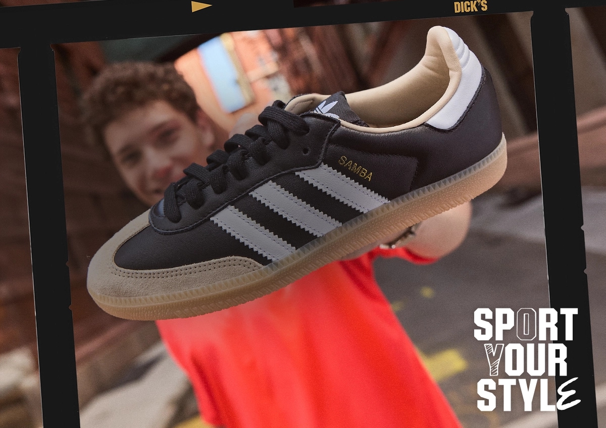 Man holding up an adidas samba shoe.