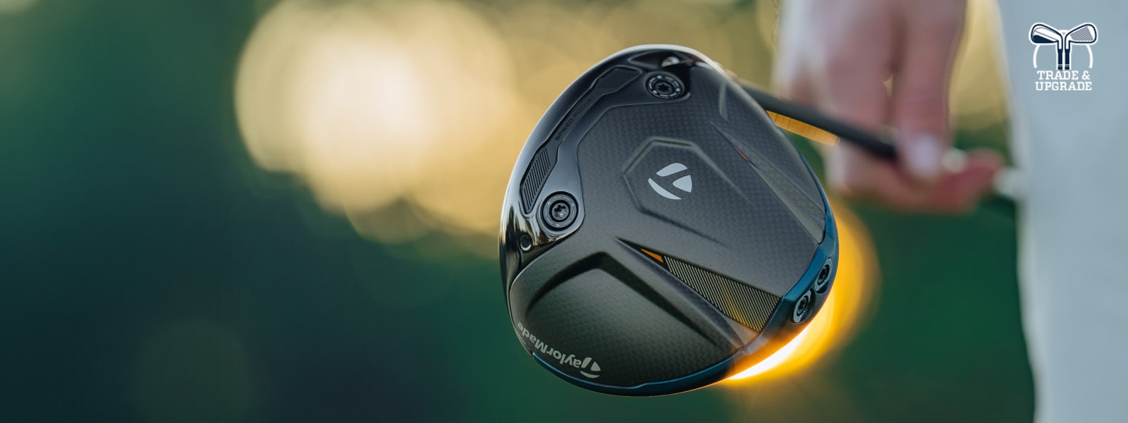 Image features a golfer swinging a driver.