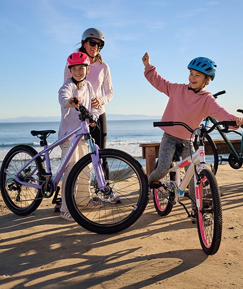 Family on bikes by the coast.