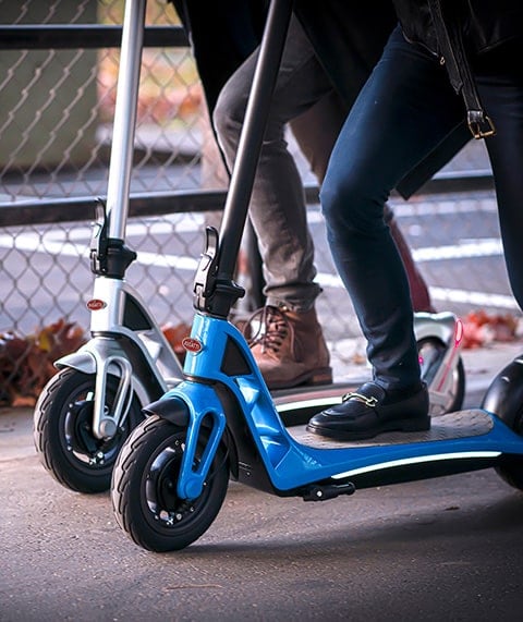 Close up of two electric scooters.