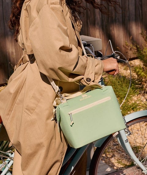 Woman holding cooler.