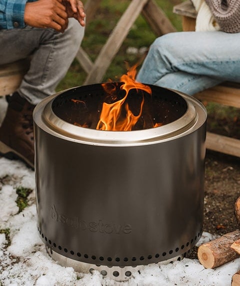 People hanging out around a fire pit.