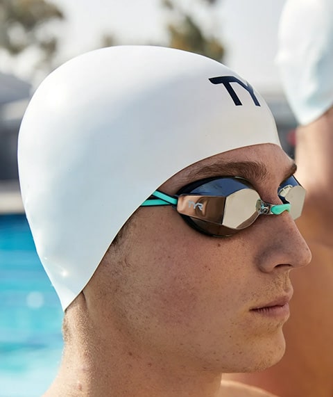Man wearing white swim cap.