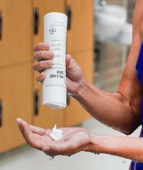 Person pouring out sunblock.