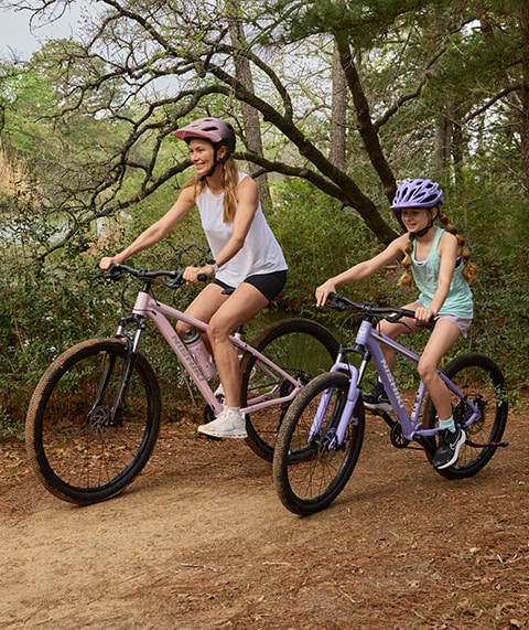 Mother and daughter on bikes.