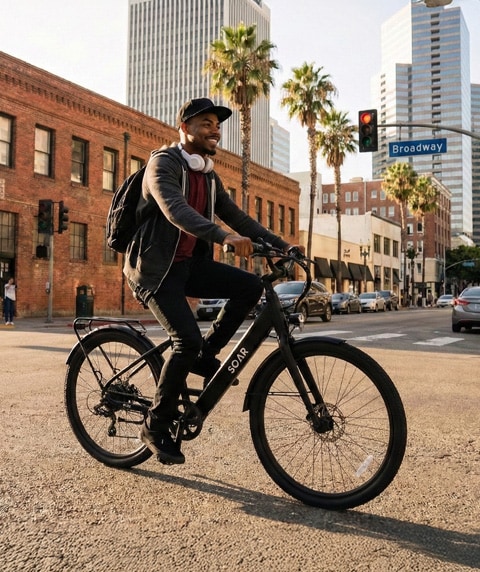 Two people riding ebikes along a path