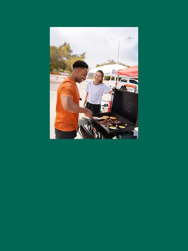 Football fans grilling at a tailgate party