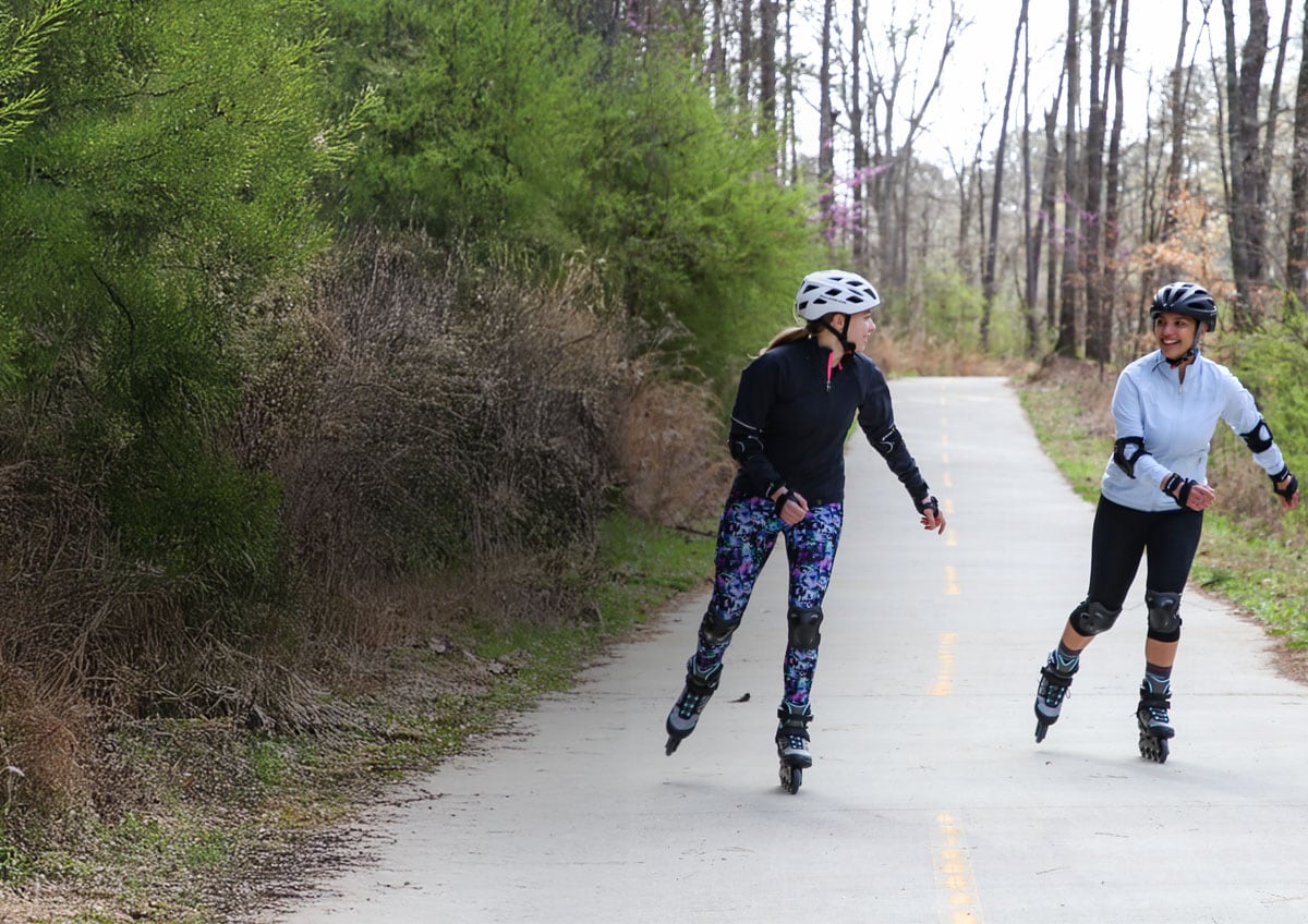 People rollerblading on a trail.