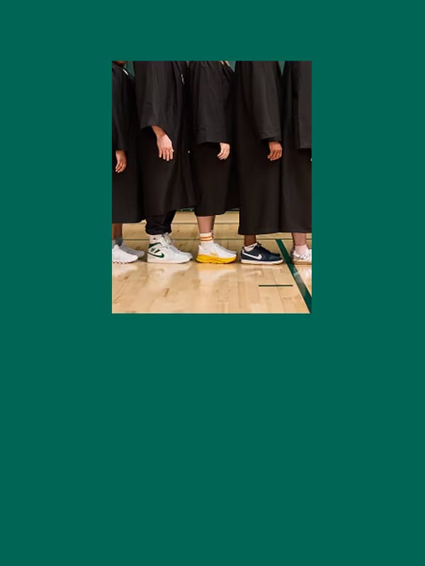 Group of people in cap and gowns in fresh new shoes.