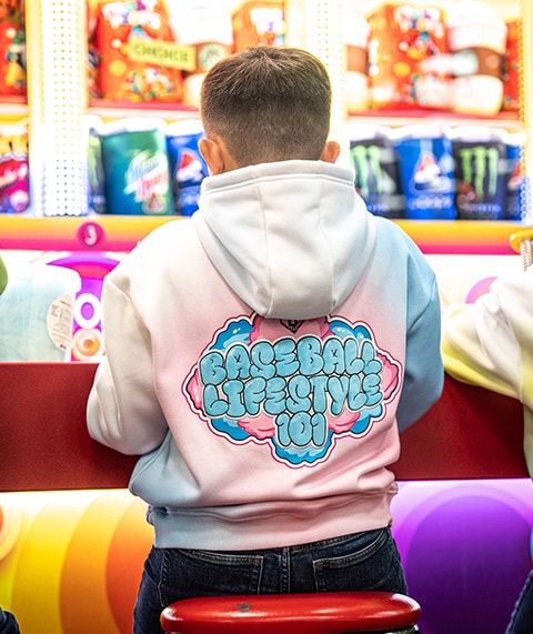 Boy sitting on a stool wearing a BL101 hoodie.