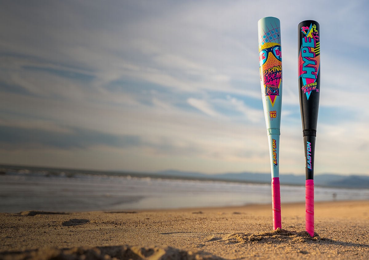 Two baseball bats on the beach.