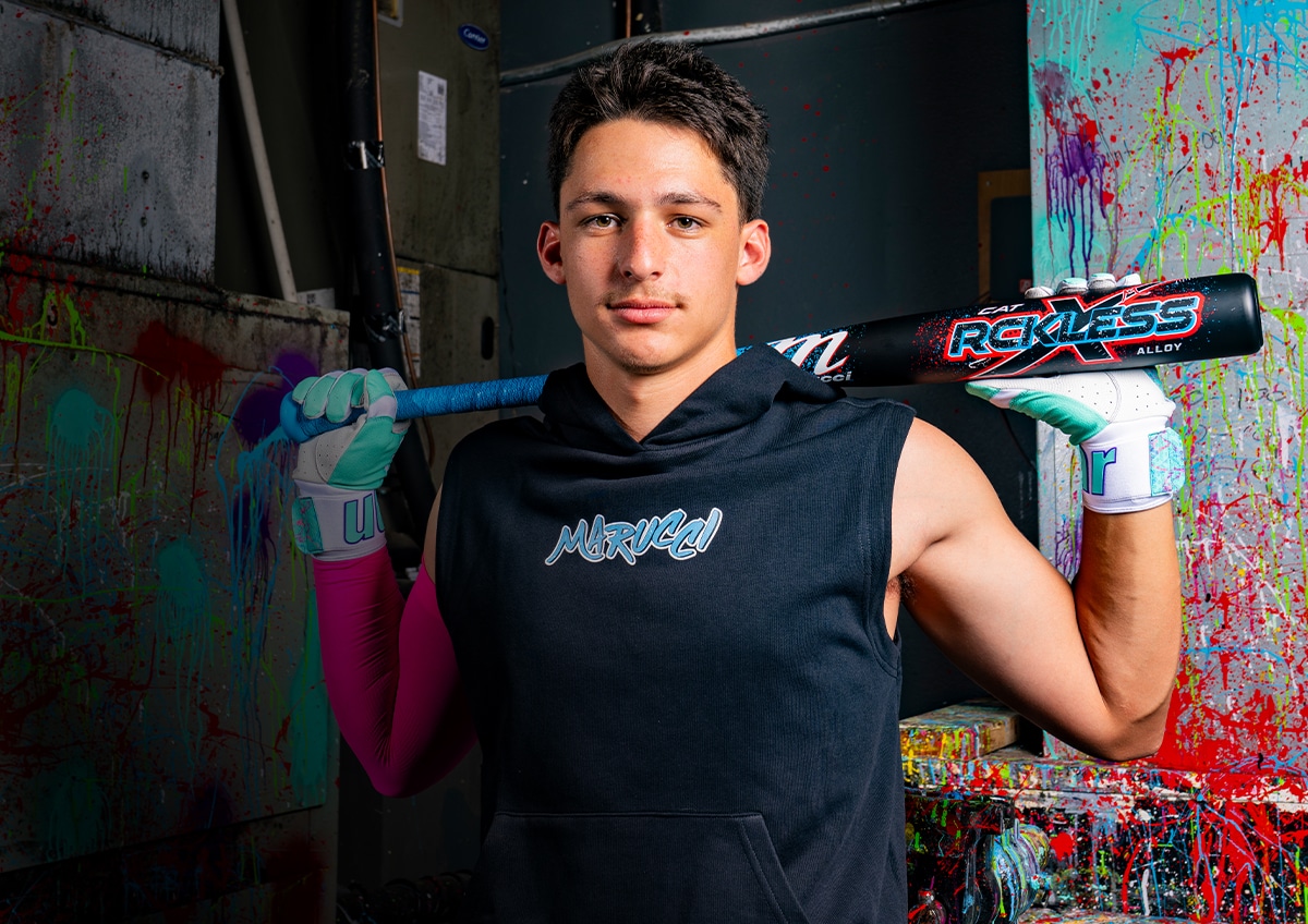 Athlete holding baseball bats.