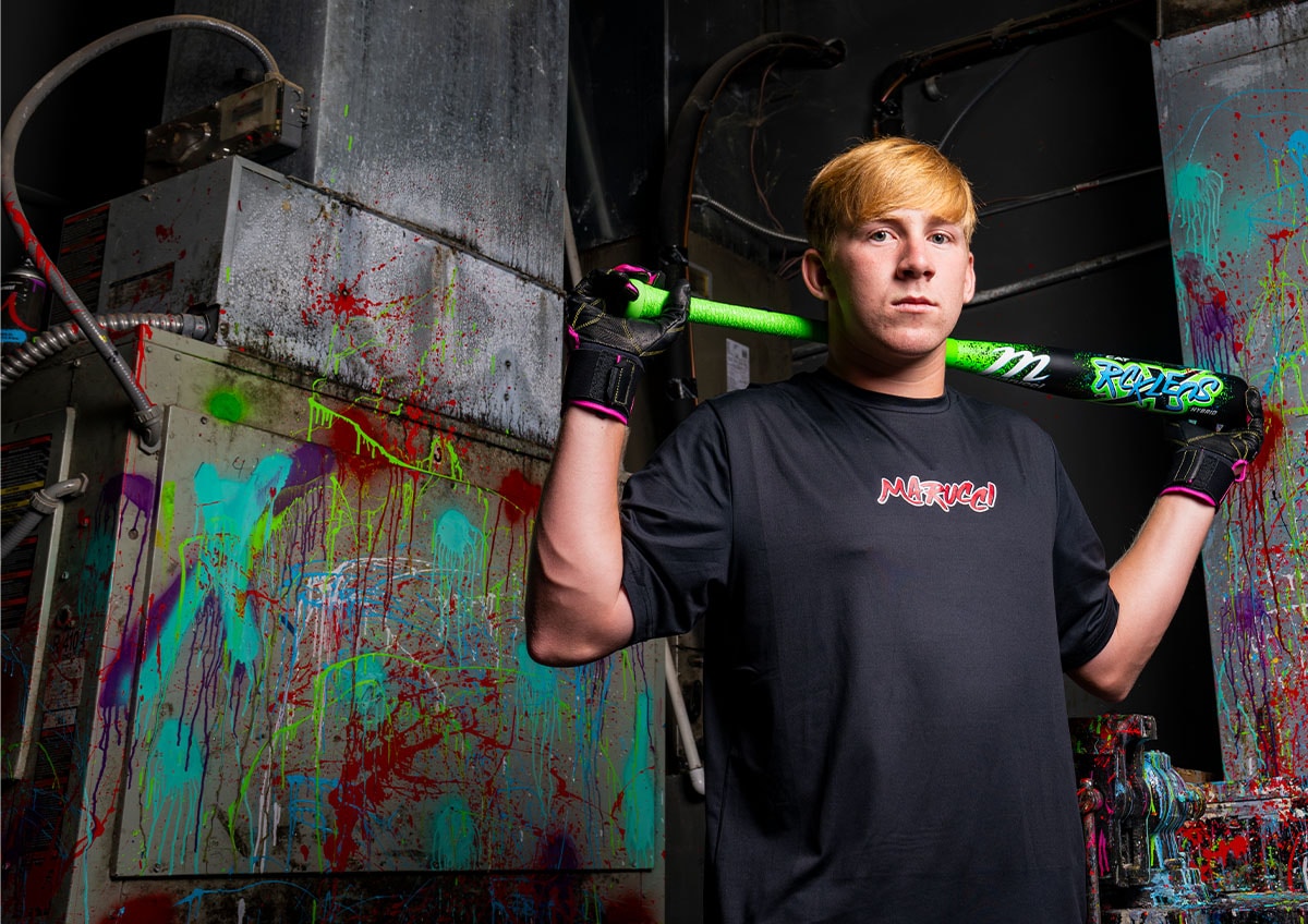 Athlete holding baseball bat.