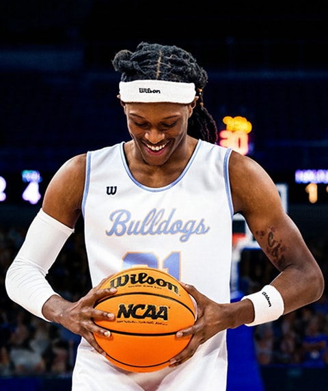 Basketball player holding basketball.