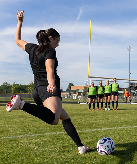 Soccer player mid-kick.