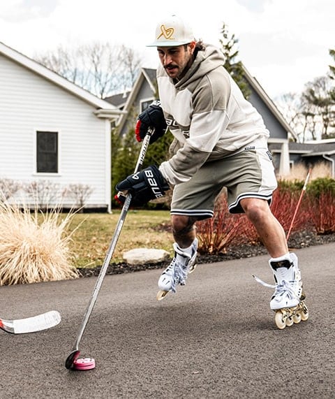 Man playing street hockey.