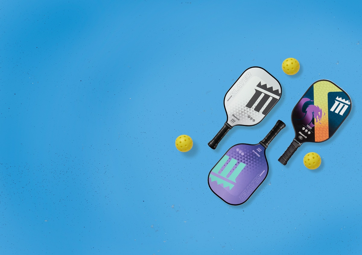 Pickleball paddles and balls laying flat on white paper