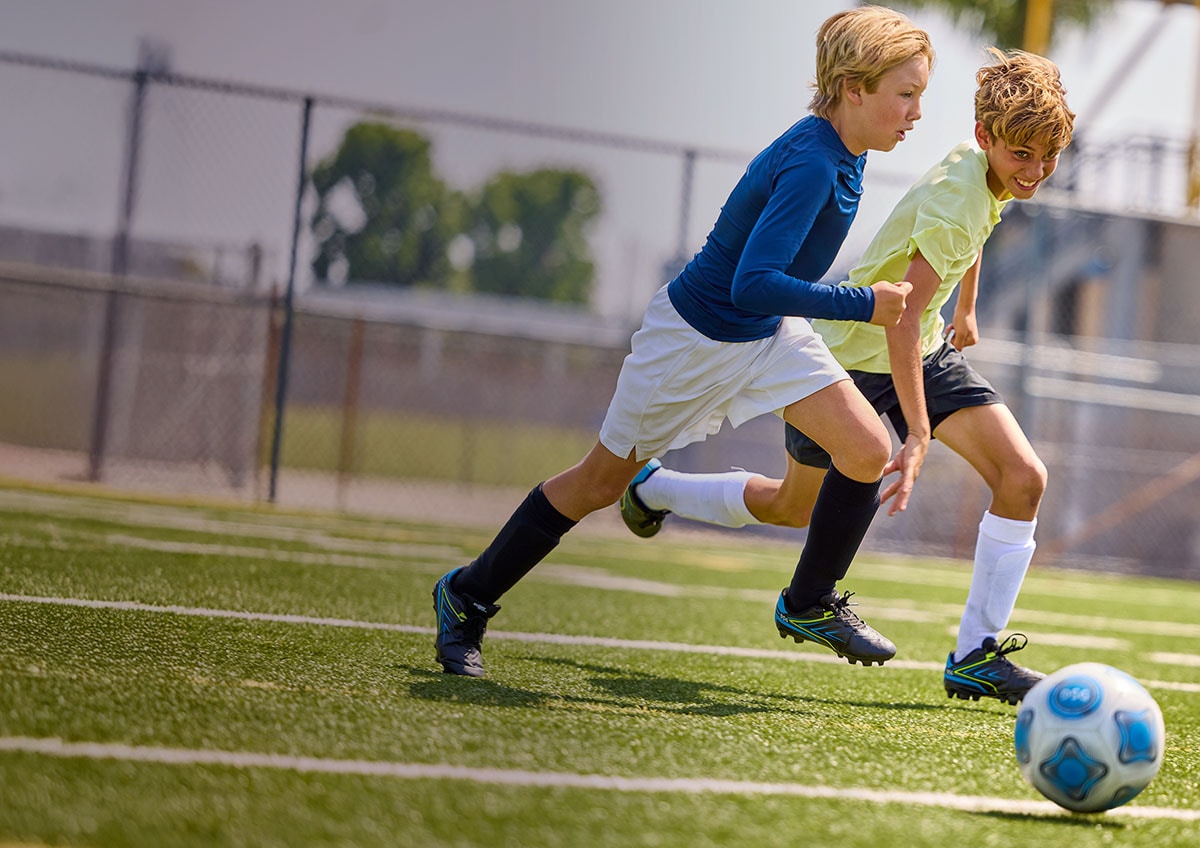 Two kids playing soccer.