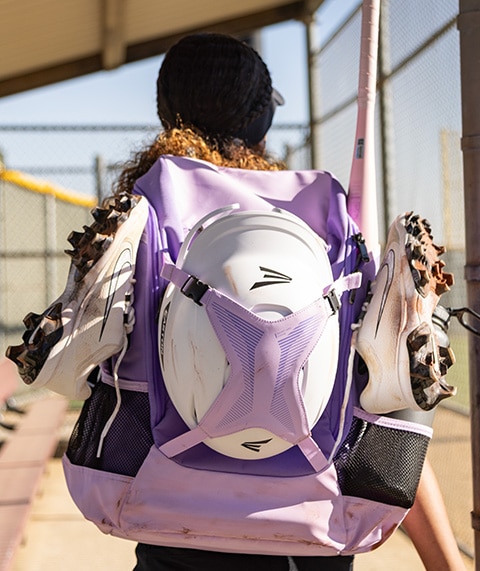 Softball player with backpack.