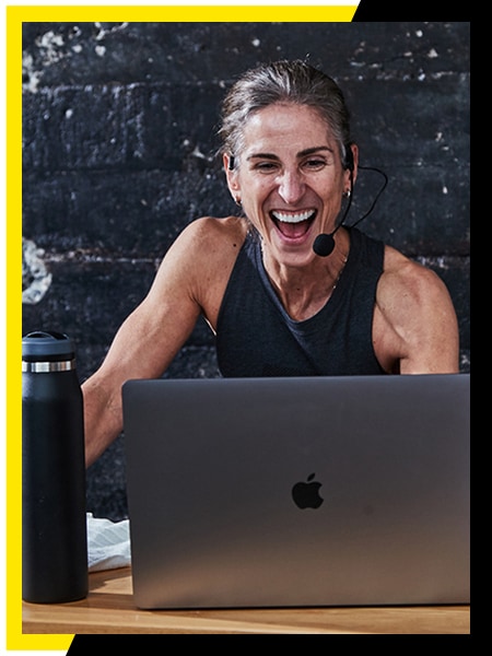 Image shows a trainer interacting with an athlete on screen.