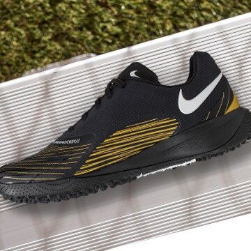Close up of field hockey shoes in grass.