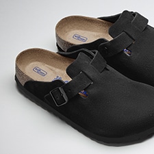 A photo of a Birkenstock sandal sticking out of a gym bag.