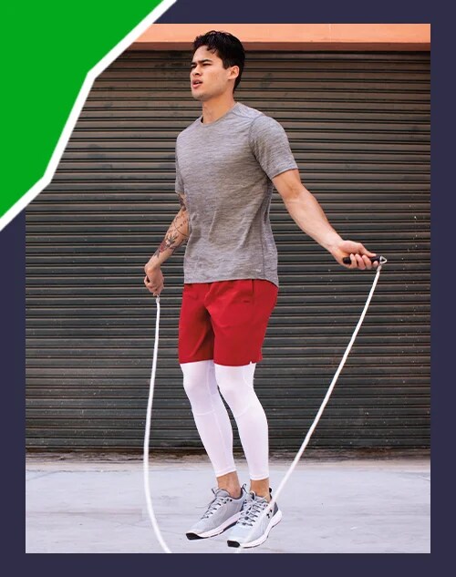 A man jumping rope in shorts.