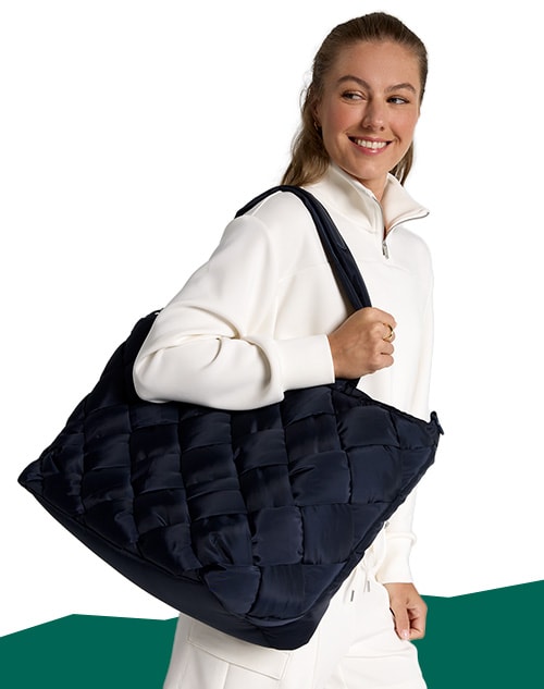 Woman with a large tote bag on her shoulder.