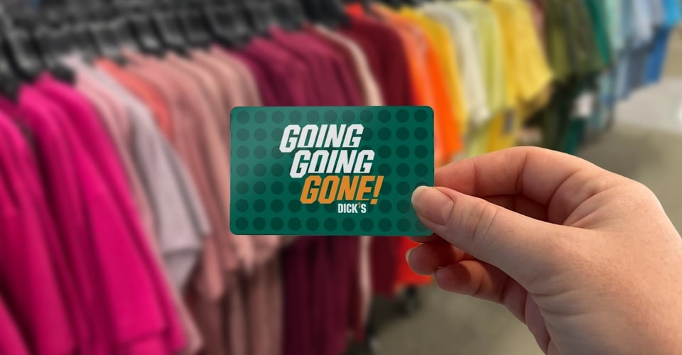 Two people handing off a Going Going Gone gift card.