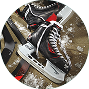 Hockey skate in a pile of skating equipment.