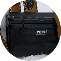 Someone reaching into a YETI cooler.