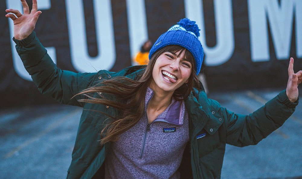 Person making silly face in winter apparel.